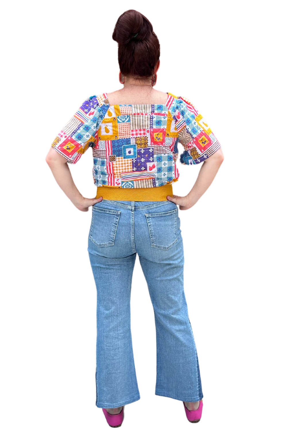 Model in blue red yellow patchwork print square neck top and jeans, back view