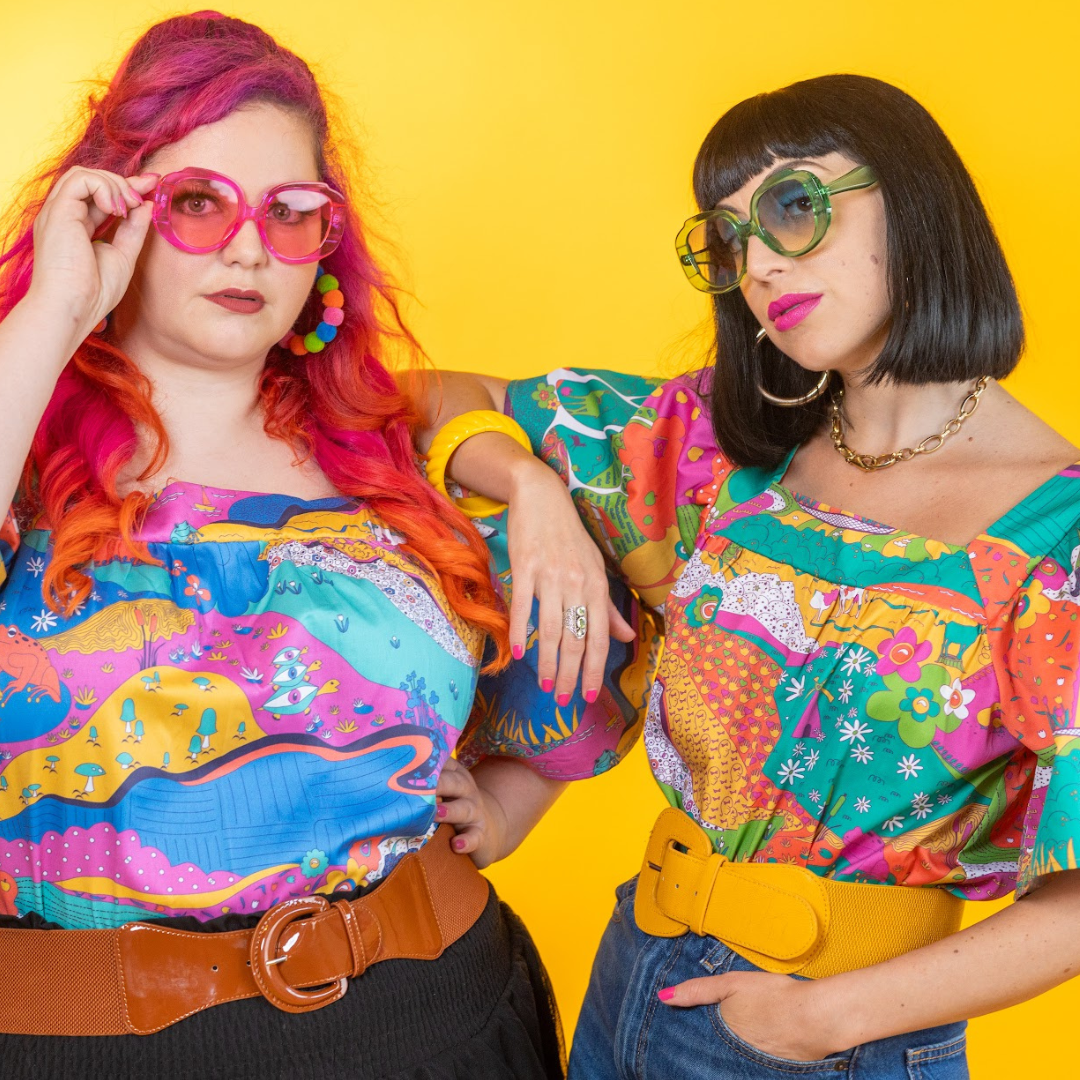 Closeup of 2 models in colorful printed shirts and big sunglasses