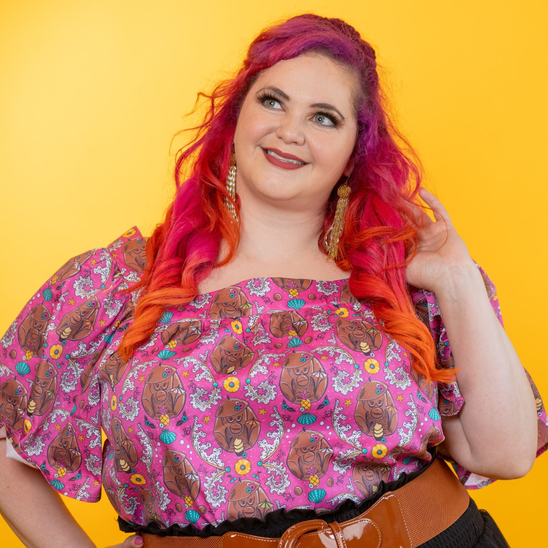 Pink-haired model wearing coconut monkey square neck top