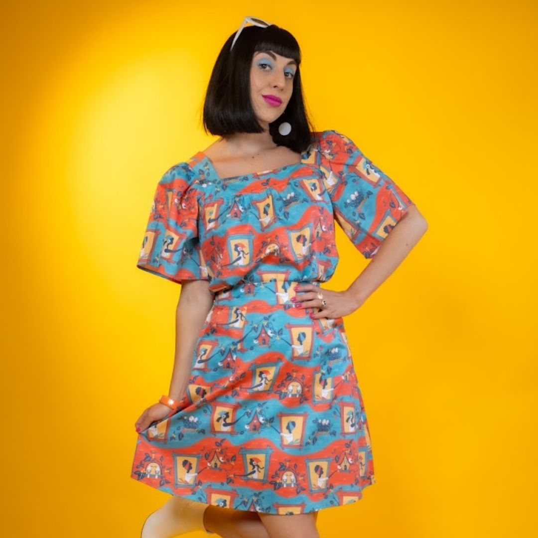 Closeup of model in matching cotton top and skirt in red and blue print