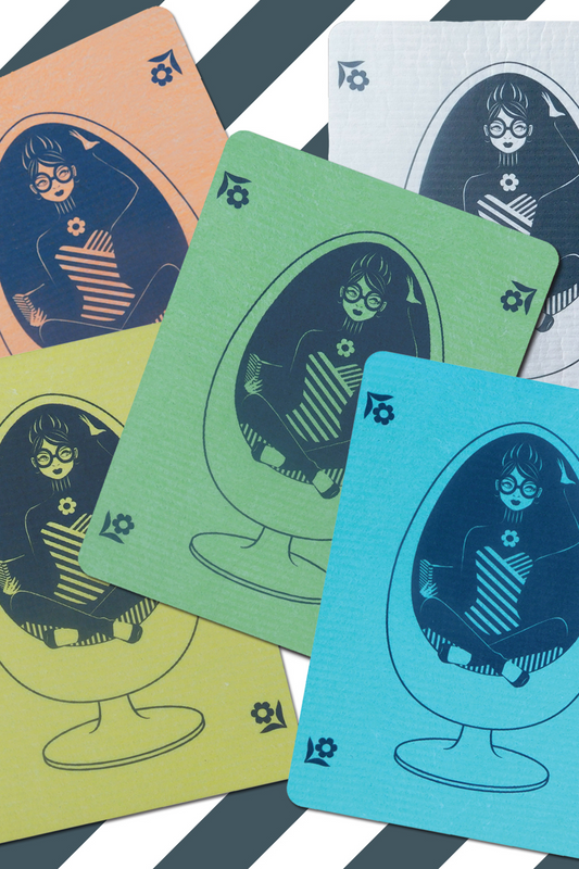 5 colorful Swedish dishcloths featuring our design of a girl in glasses reading in a vintage egg chair