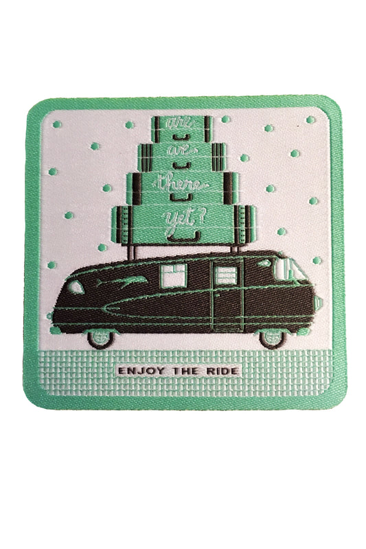 Iron on patch featuring a grey motorhome, suitcases on top, and Enjoy the Ride with mint green polka dots and border