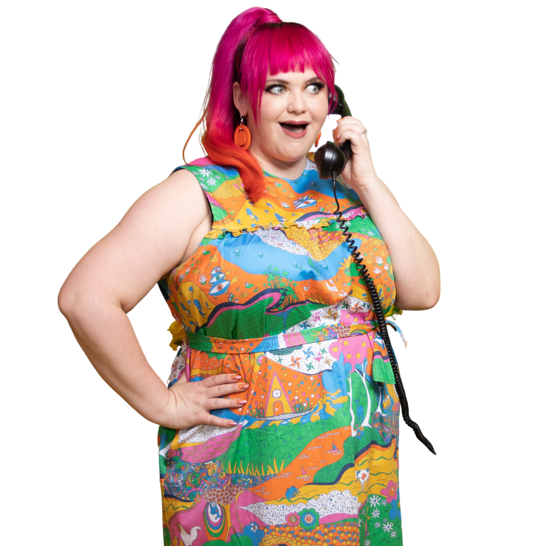 Radiant pink haired model wearing rainbow colored psychedelic maxidress and talking on phone
