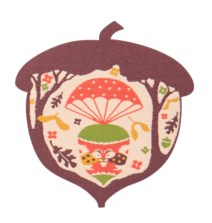 Brown, green and orange acorn-shaped iron on patch with parachuting squirrels and leaves