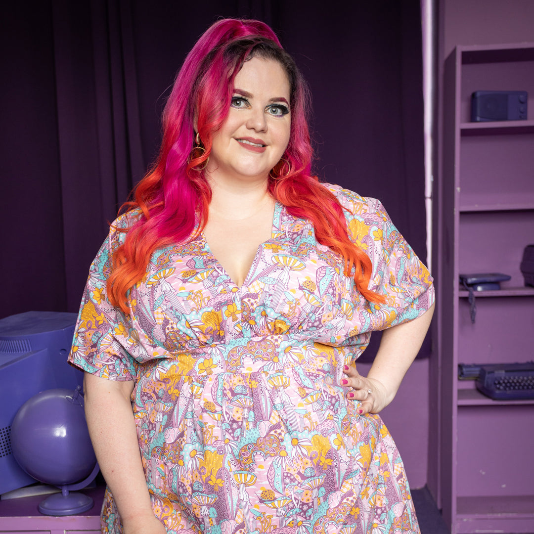 Pink, aqua and yellow v-neck mushroom, flower and snail print maxi caftan on pink-haired model