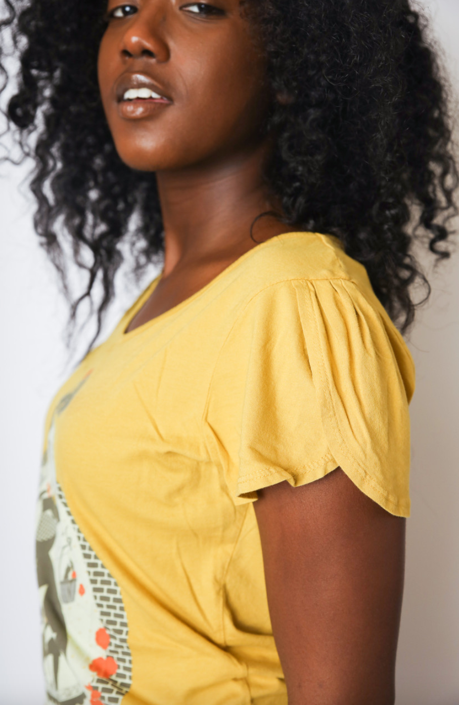 Side view of yellow tulip sleeve Wizard of Oz inspired graphic tee