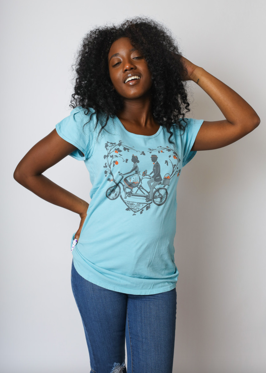 Sky blue tee with older couple riding tandem bicycle on African American model
