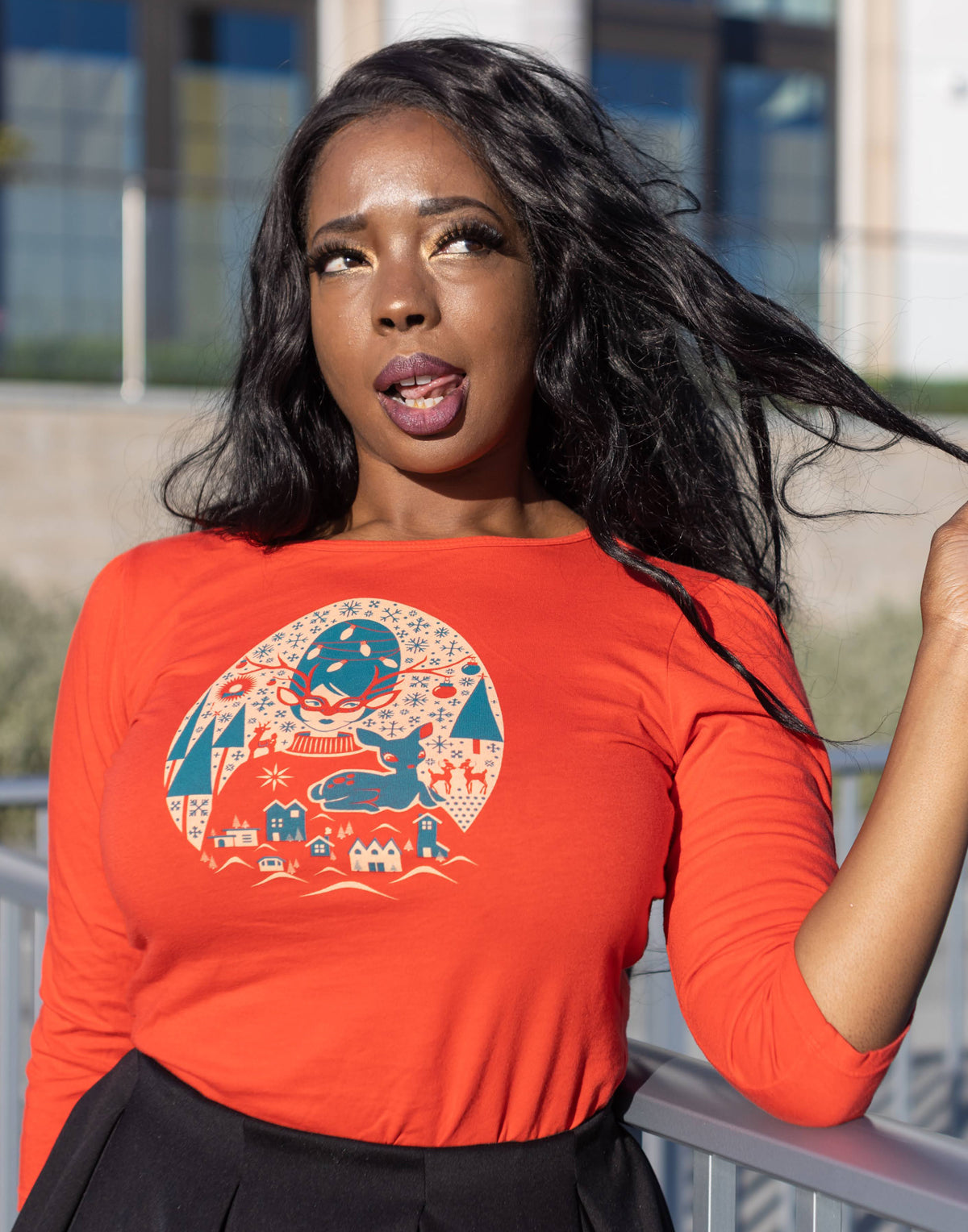 Cute model wearing red Christmas themed 3/4 sleeved tee