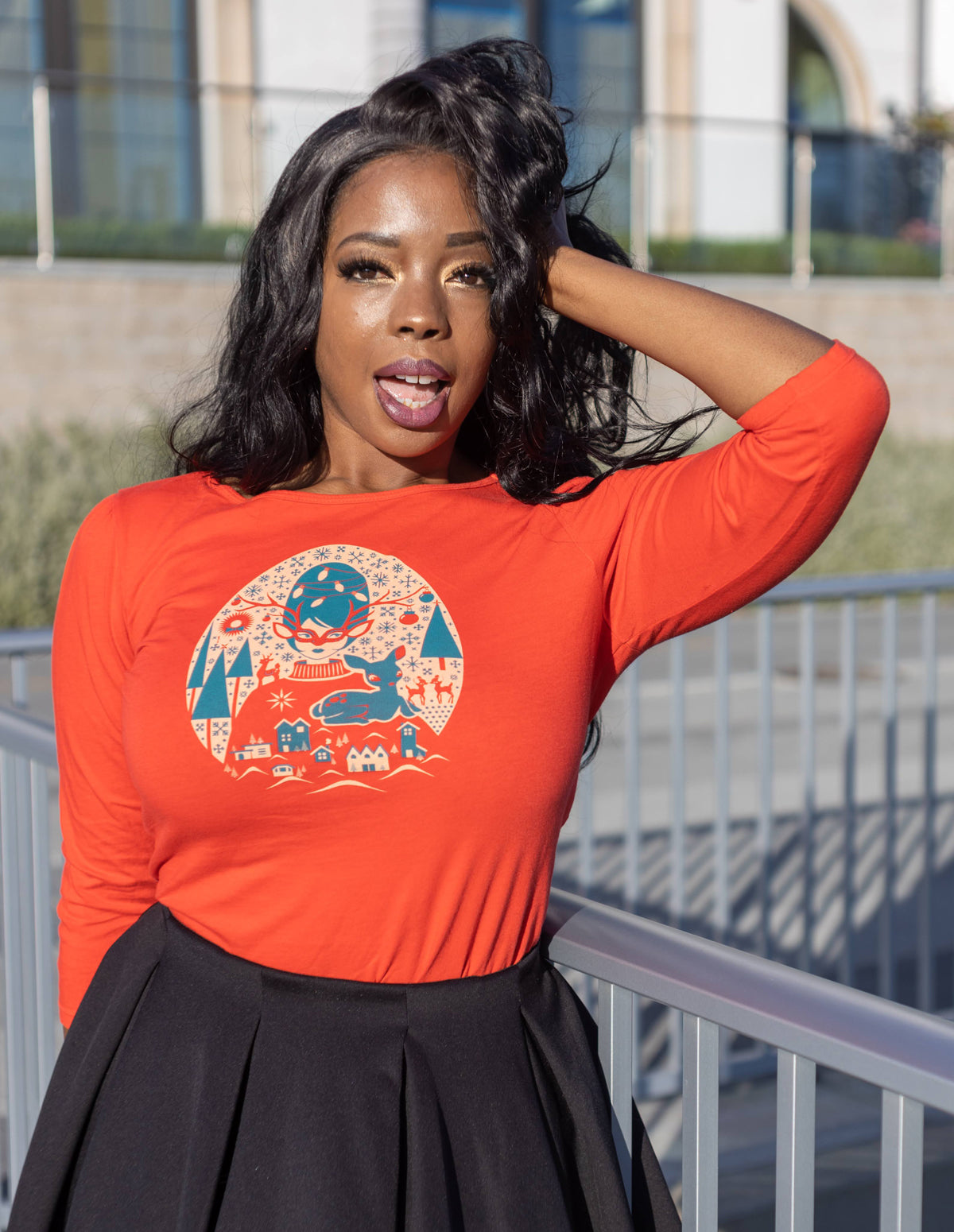 Dark skinned model wearing red Christmas themed 3/4 sleeved tee