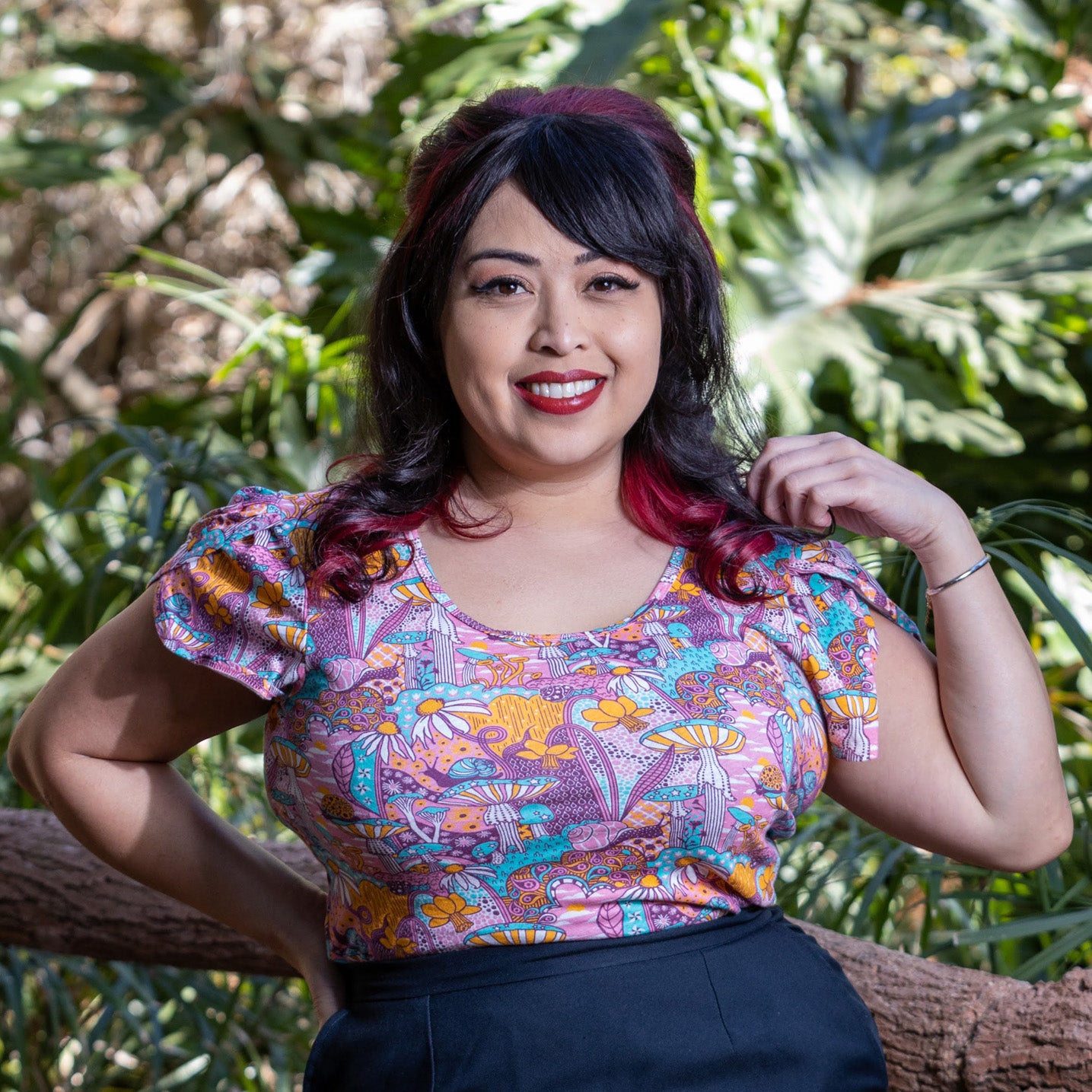 Pink mushroom, snail and flower print tulip-sleeved tee on Latina model