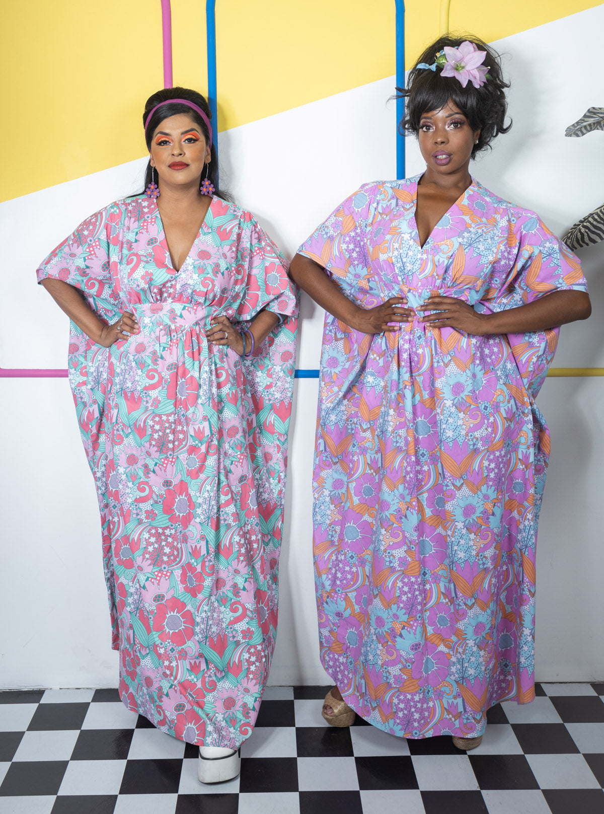 2 models in bold floral caftan dresses