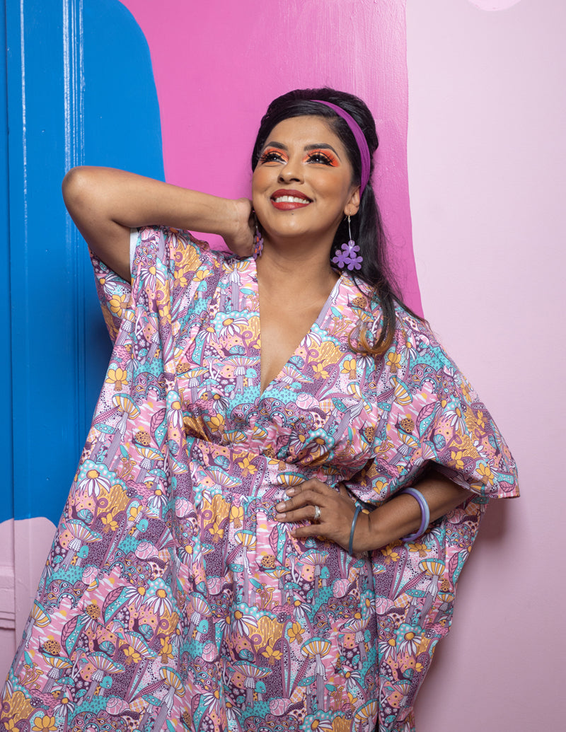 Pink v-neck mushroom, flower and snail print maxi caftan on dark-haired model