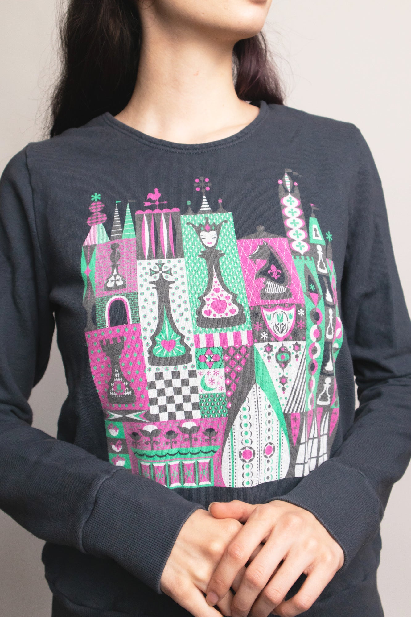 Closeup of grey chess print pullover sweatshirt on young woman