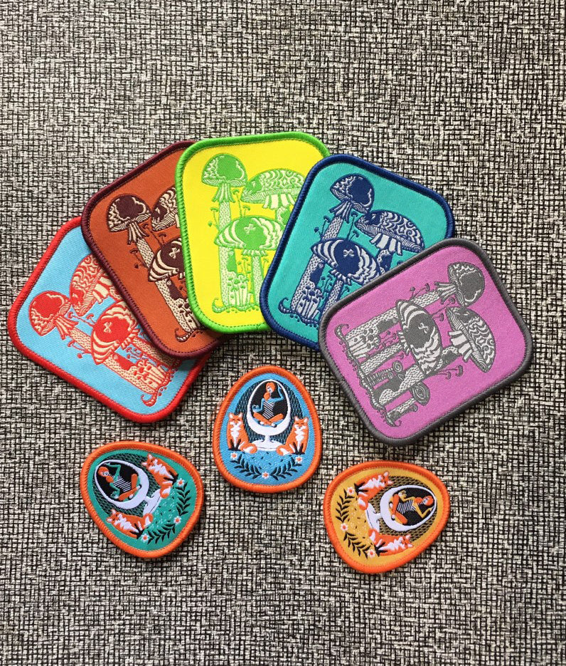 Several colorful iron on patches with mushrooms and foxes
