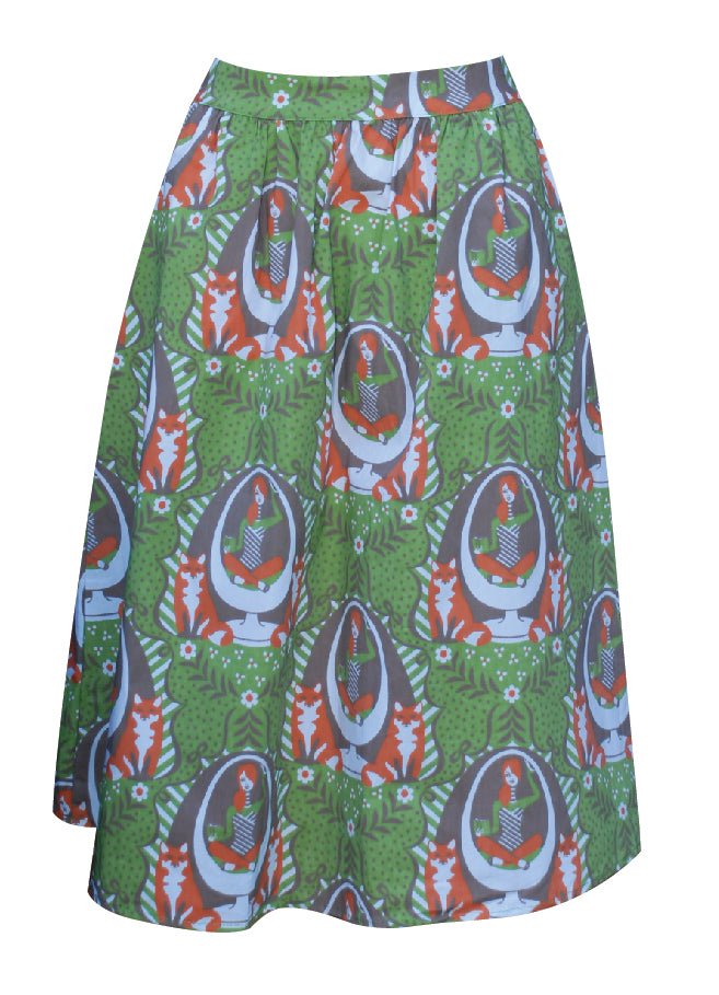Olive green and orange gathered midi skirt with print of girl reading in egg chair with foxes and big orange zip