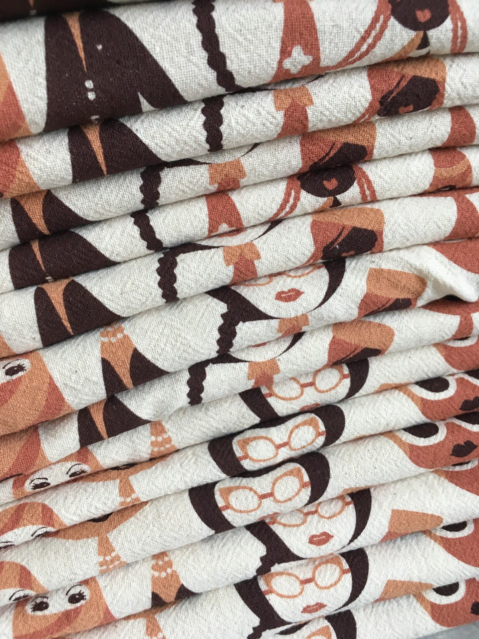 A dish towel featuring a variety of women