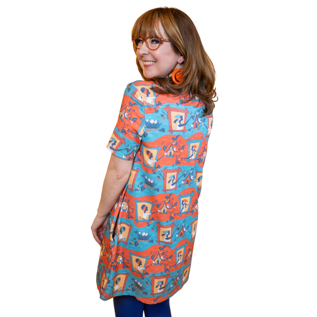 Back view of red and blue tunic with birdhouses and girls in windows