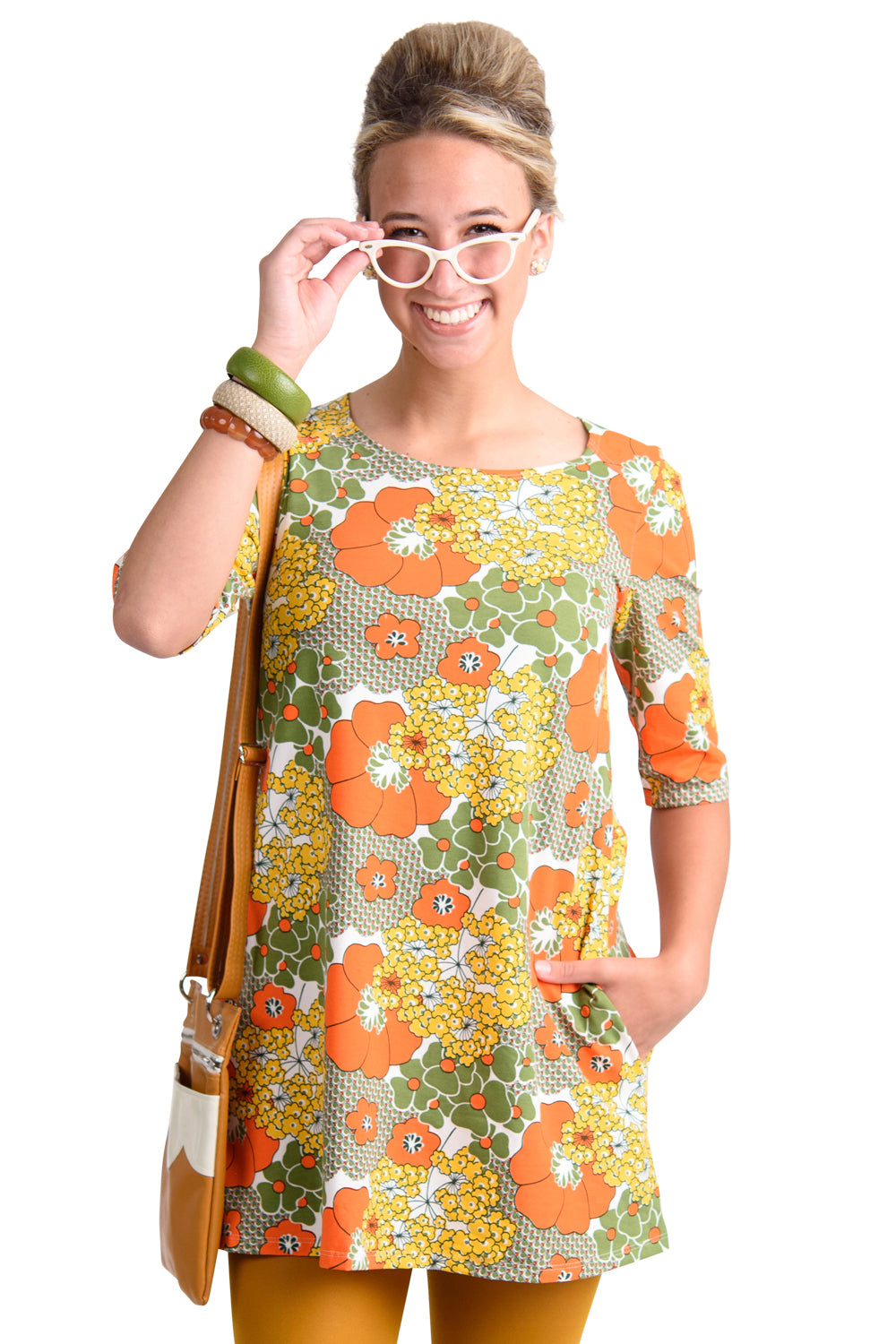 Model wearing pocket tunic in orange and olive with graphic of flowers
