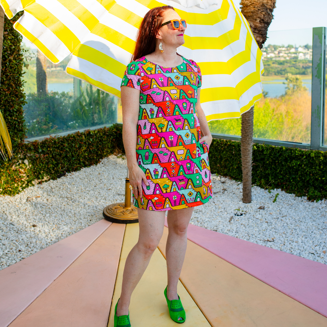 Designer in geometric print tunic minidress in the California sun