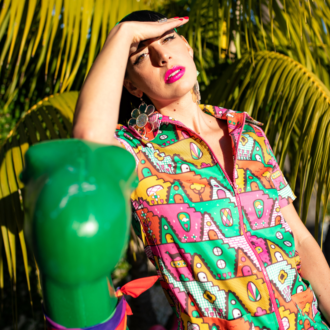 Dark-haired model in bold geometric print jumpsuit with big collar and contrast zipper