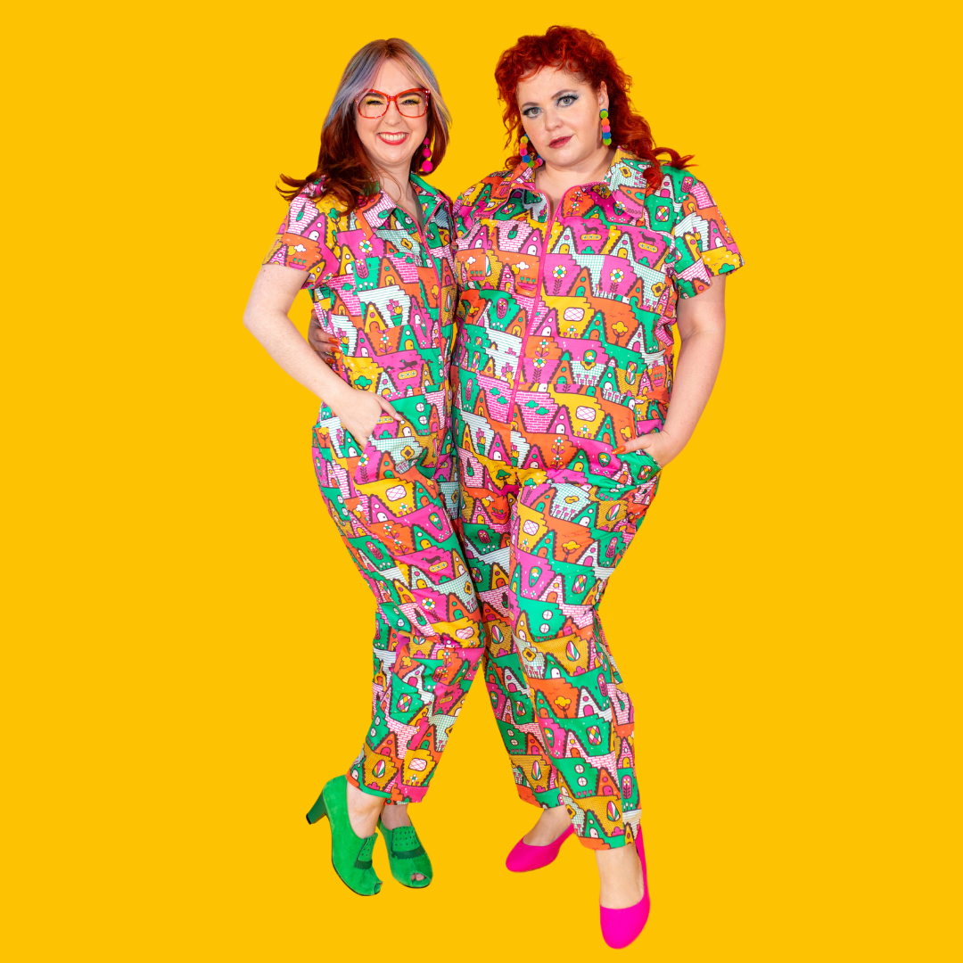 2 cute girls in matching geometric print jumpsuits in bright colors, and bright accessories