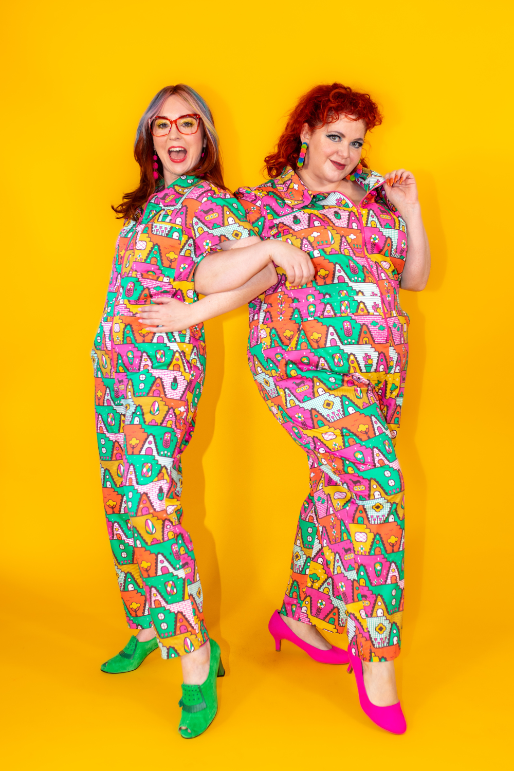 2 cute girls in orange, yellow, pink and green geometric print jumpsuits and brightly colored accessories