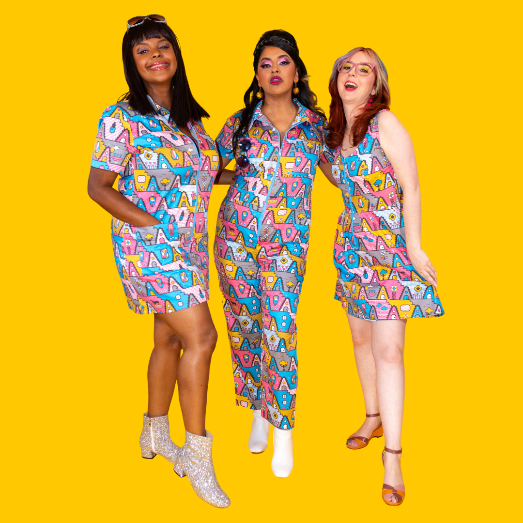 3 models in matching print of pink, yellow and blue houses, animals and plants