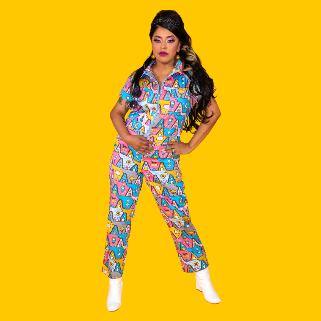 Latina model with long hair and pastel geometric print jumpsuit and boots
