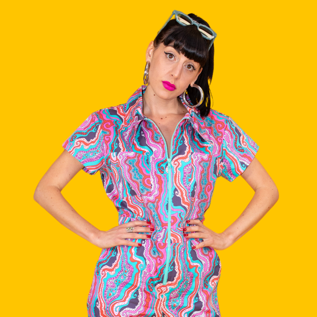 Dark-haired model with big earrings and funky vintage inspired jumpsuit