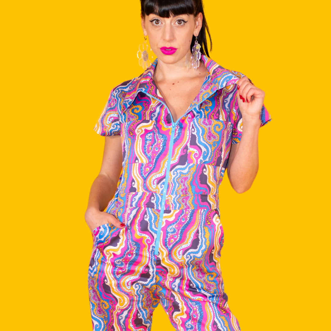 Closeup of model in bright lipstick and bold psychedelic print jumpsuit