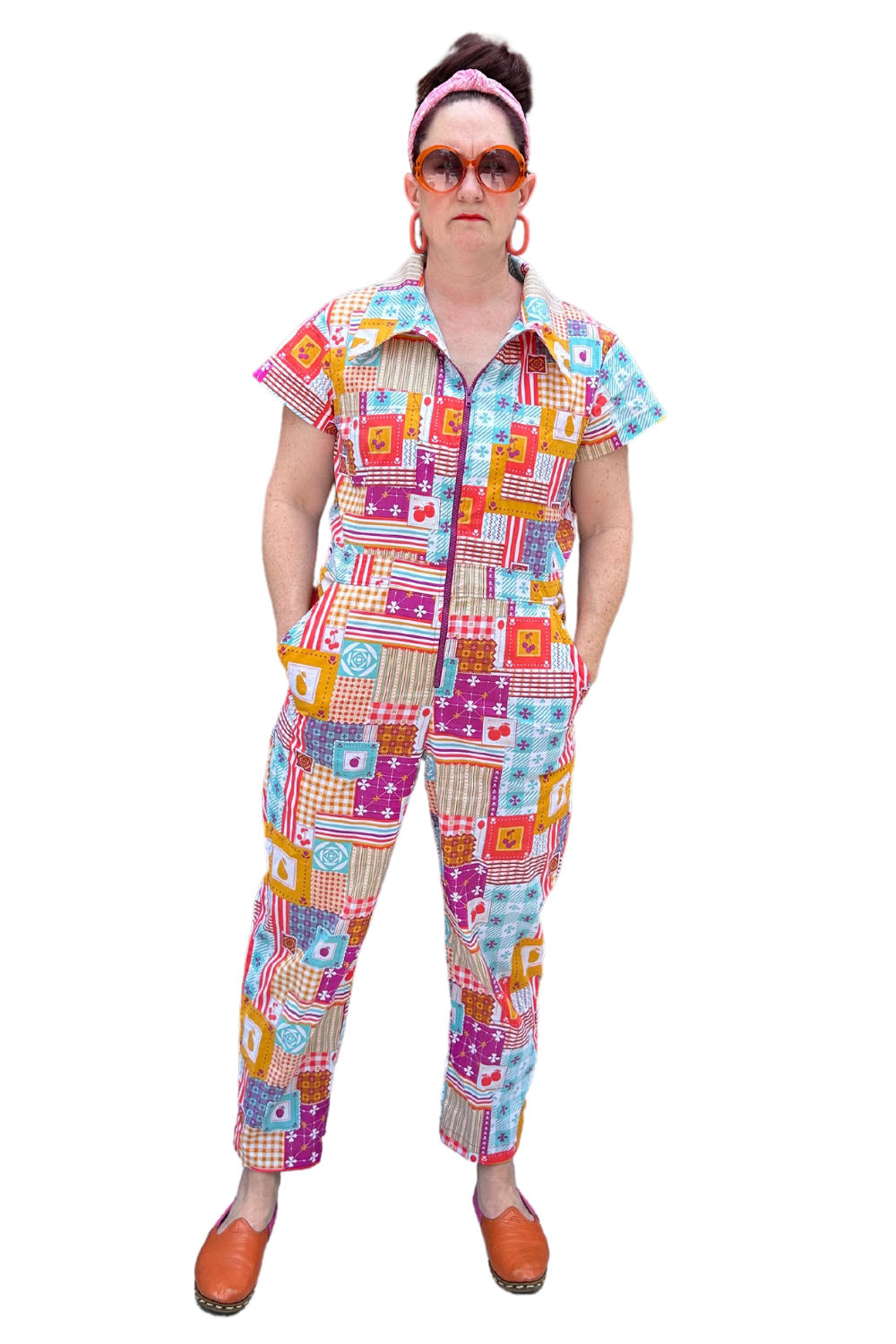 Model wearing sunglasses and patchwork print zip-front collared jumpsuit