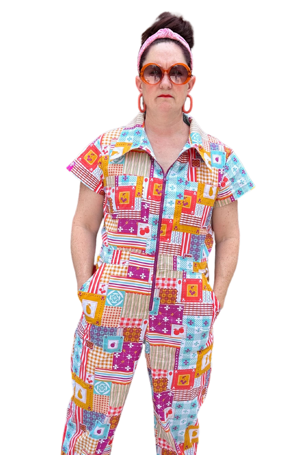 Model wearing sunglasses and patchwork print zip-front collared jumpsuit