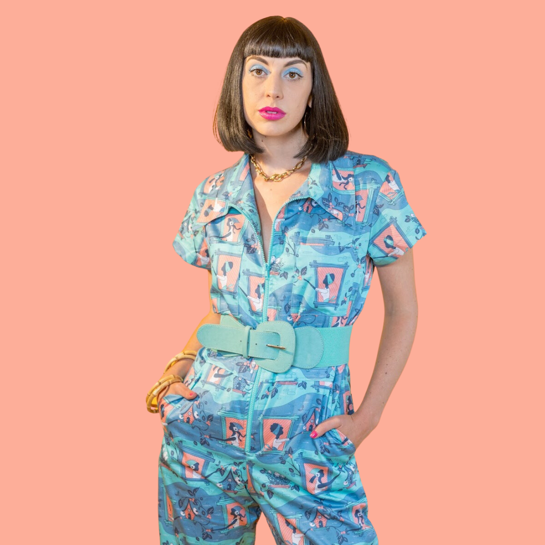 Crop of dark haired girl in aqua and peach jumpsuit with fun graphic print