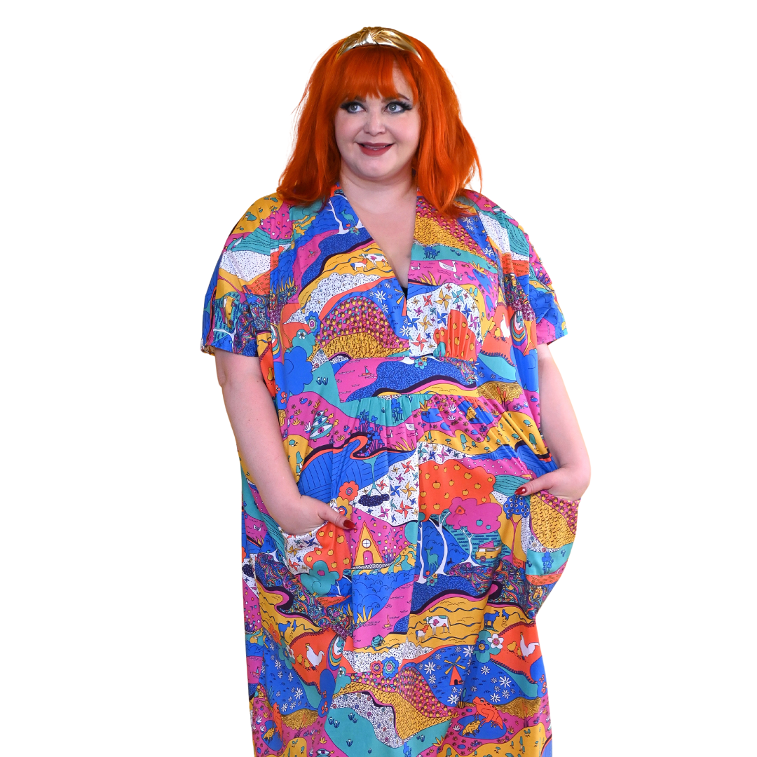 Red-haired model in colorful landscape print caftan