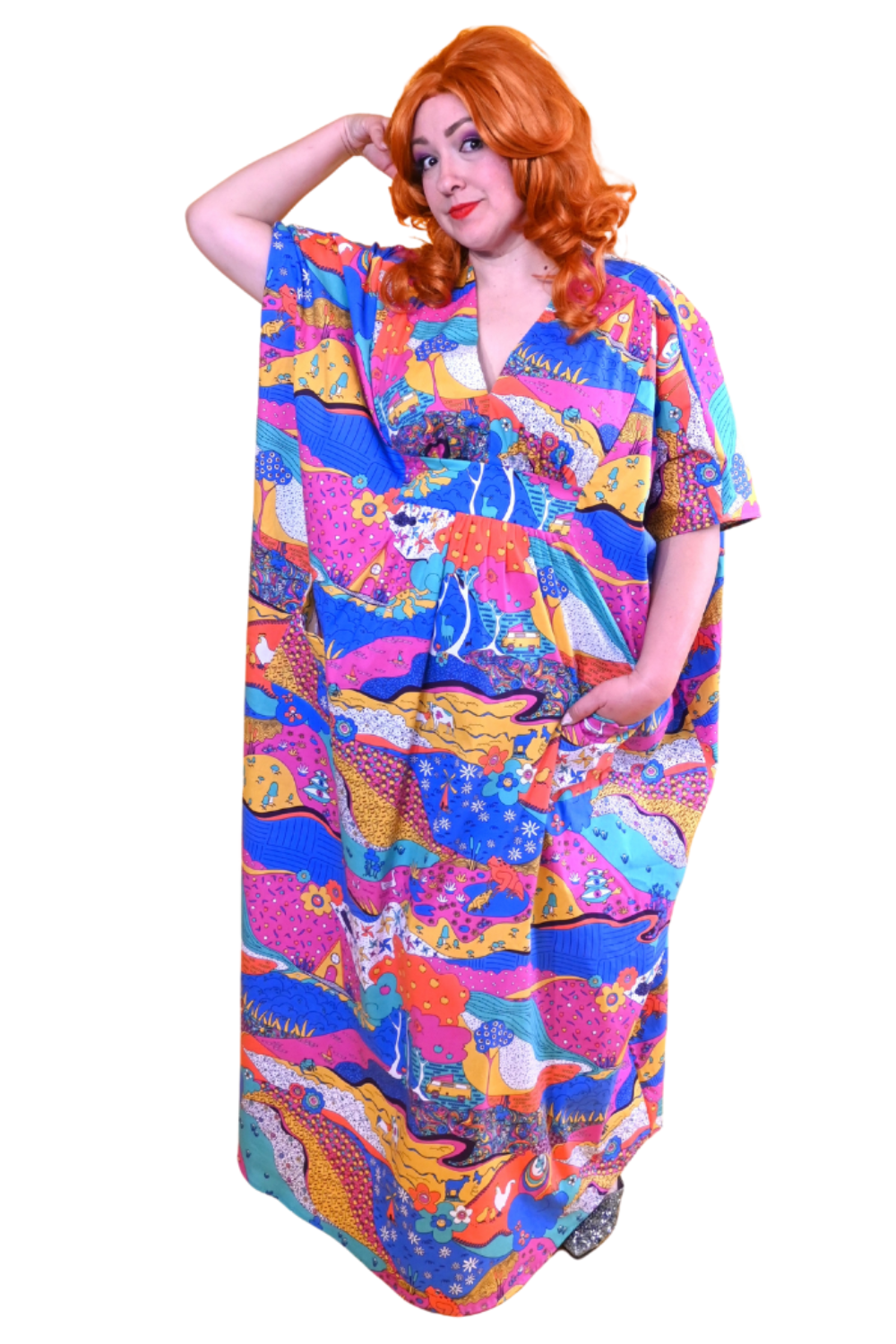 Red-haired model in colorful landscape print caftan