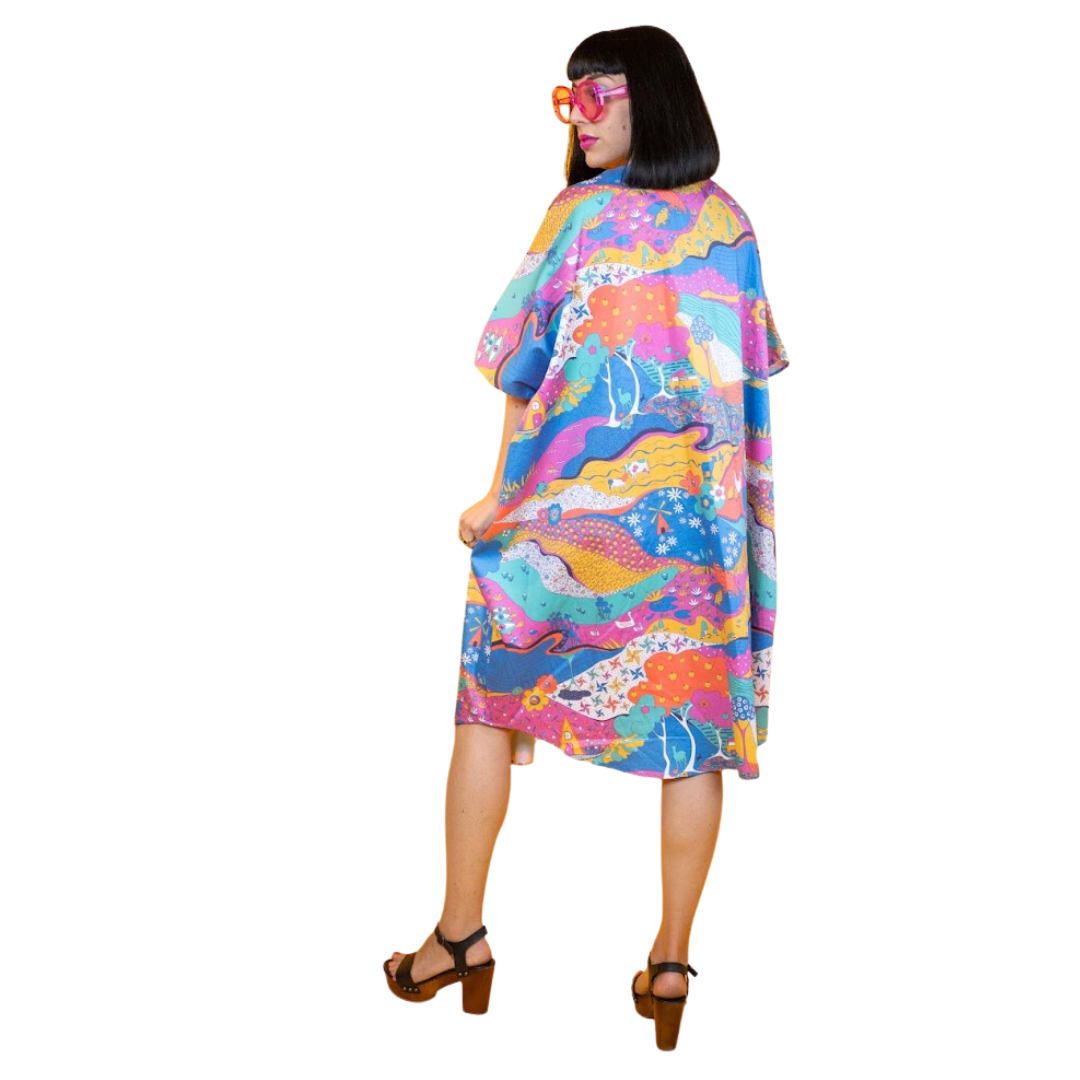 Back view of model in colorful printed midi caftan dress