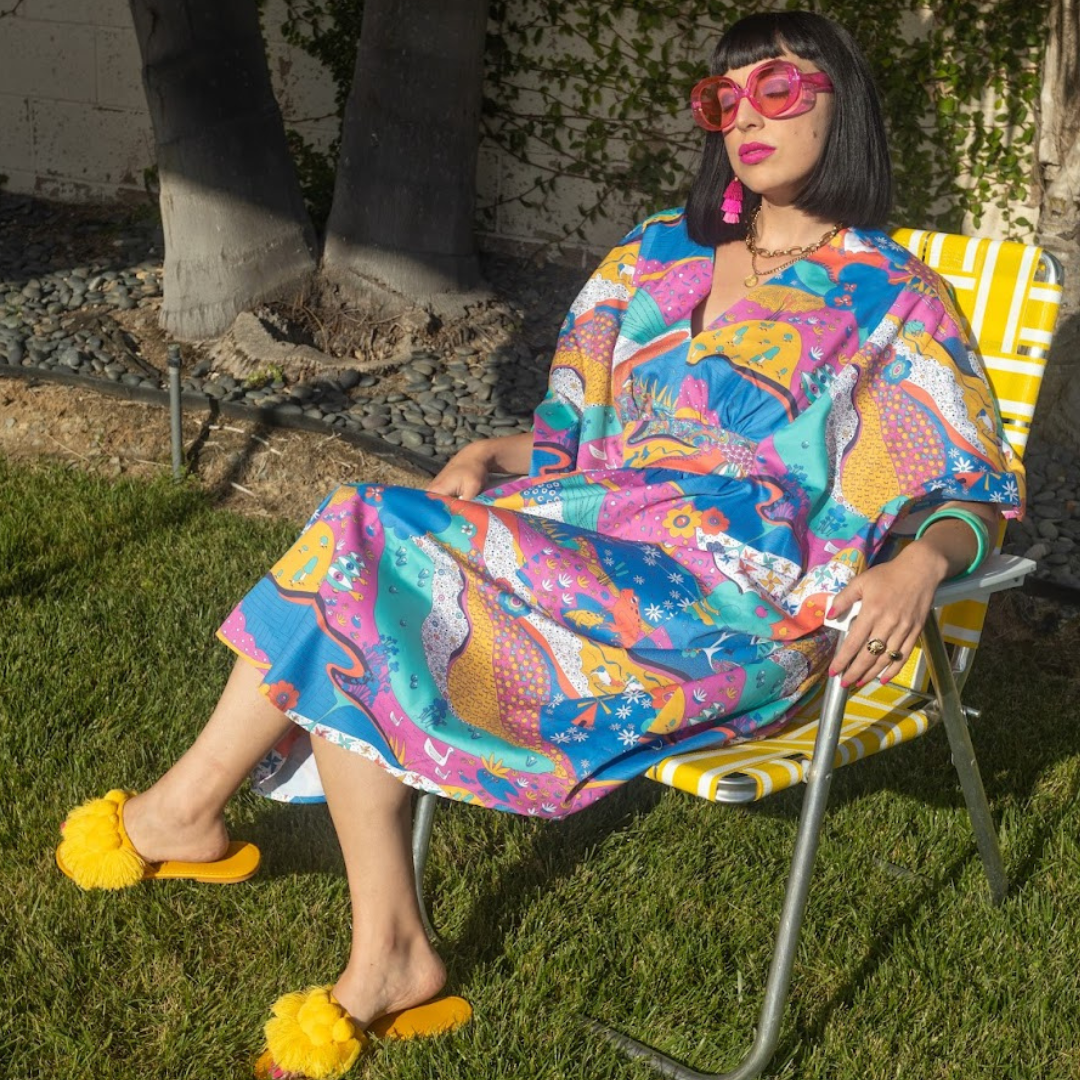 Model sunning herself in cotton caftan and lawn chair