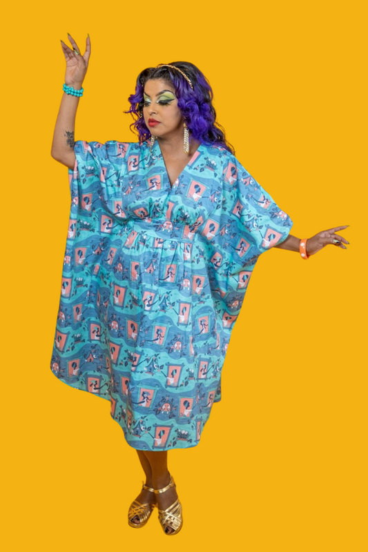 Pretty model posing in mint, grey and peach caftan with graphic print of women feeding birds and birdhouses