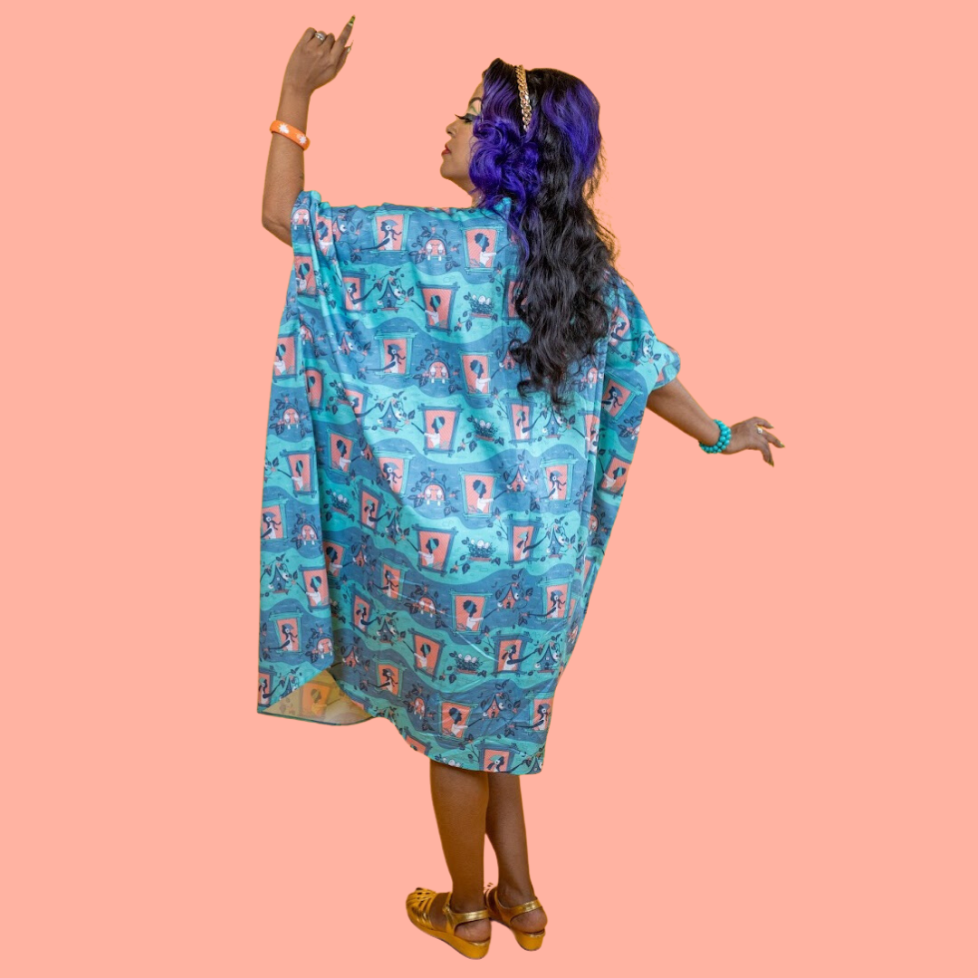 Back view of caftan featuring print of girls feeding birds and birdhouses in mint and grey