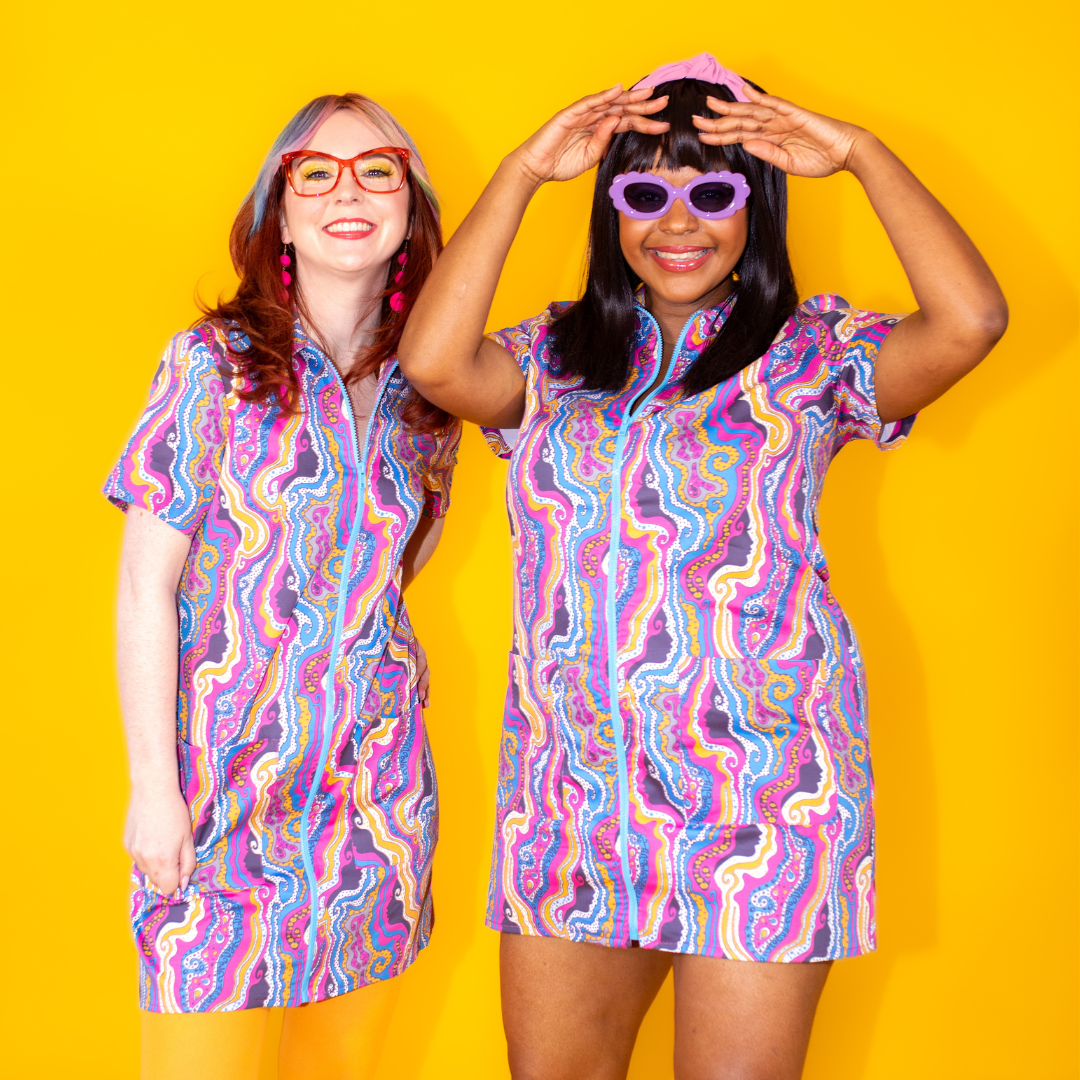 Closeup of 2 models in matching psychedelic print minidresses