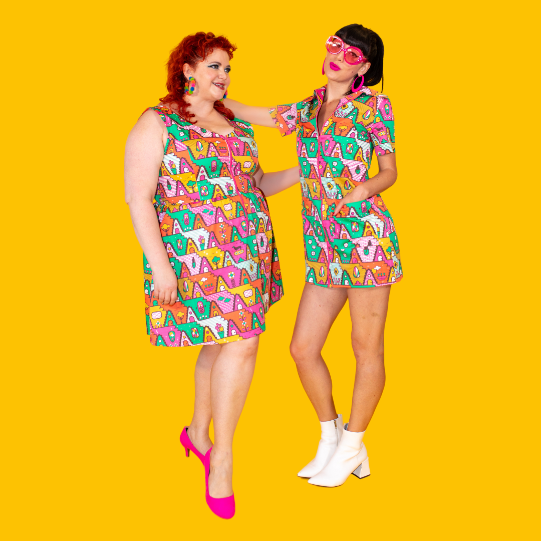 2 models wearing brightly colored geometric print dresses and fun accessories