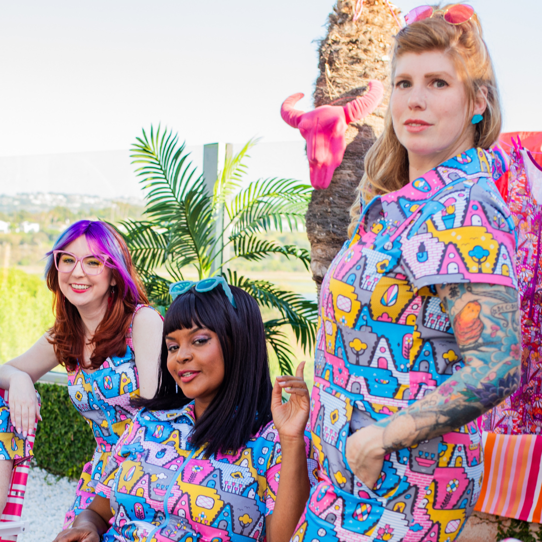 3 models in coordinating geometric print featuring houses, trees and animals