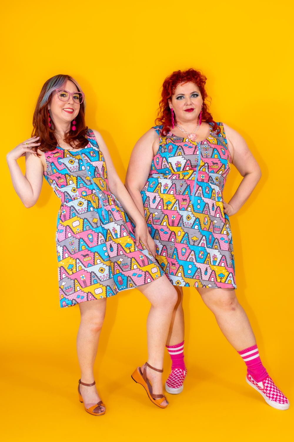 2 stylish models in bright geometric print dresses in 80s inspired pastel palette