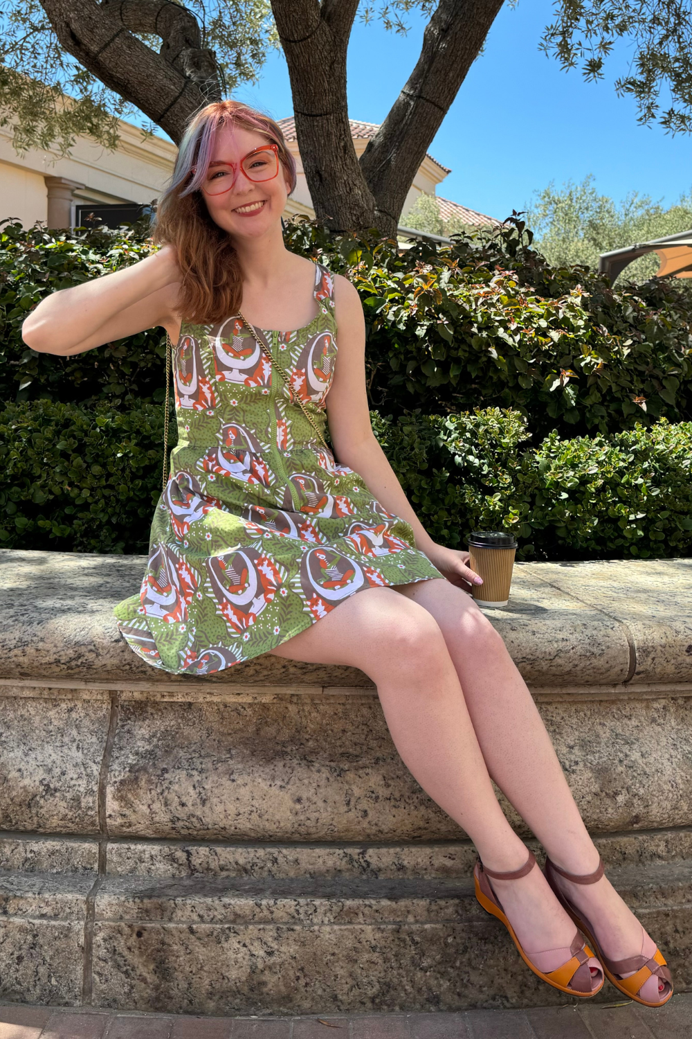 Model in olive green dress with reading girls, foxes and egg chairs