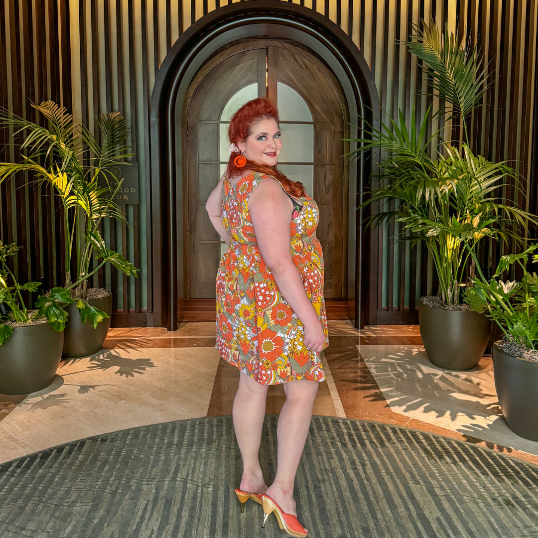 Side view of red haired model in groovy floral dress 