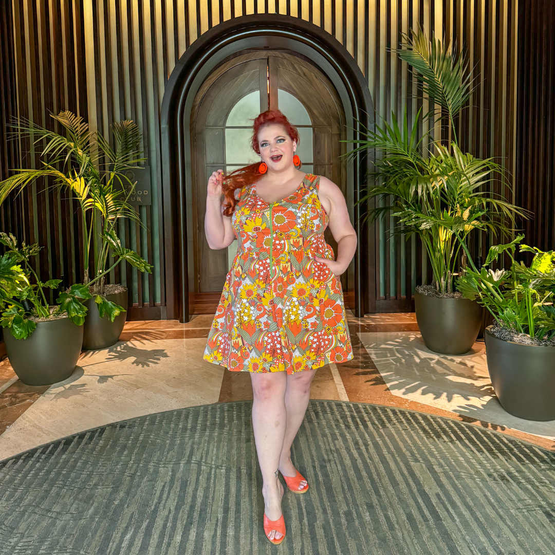 Red-haired model  in sleeveless retro flower print dress