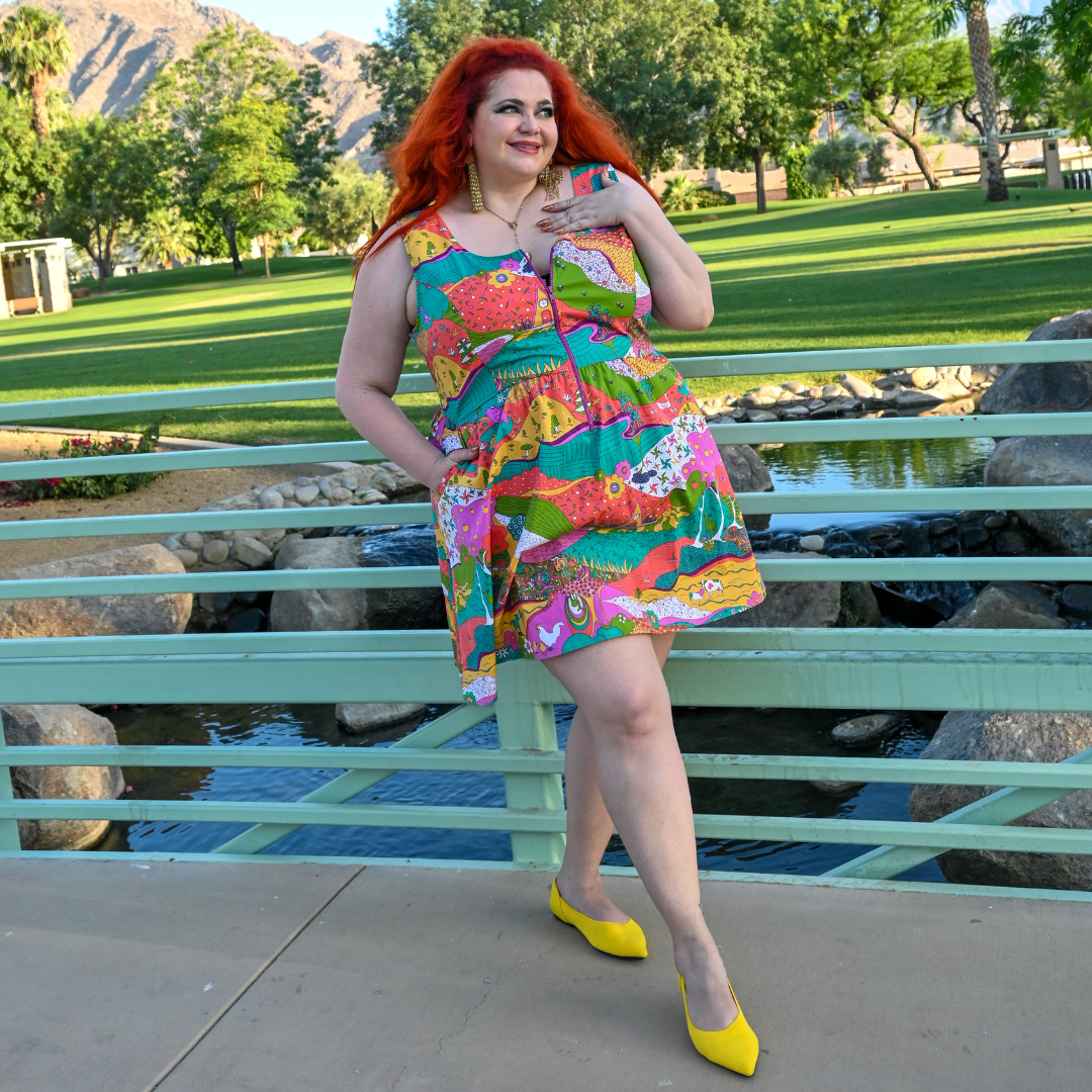 Red-haired model in bold animal and floral print fun sundress