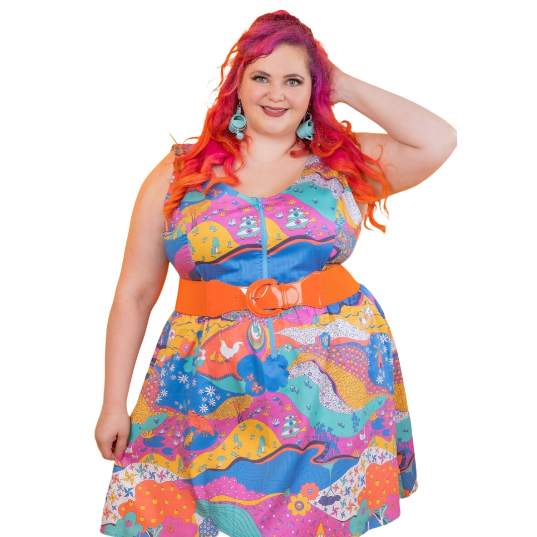 Closeup of red-haired model in sleeveless zip-front dress with big belt