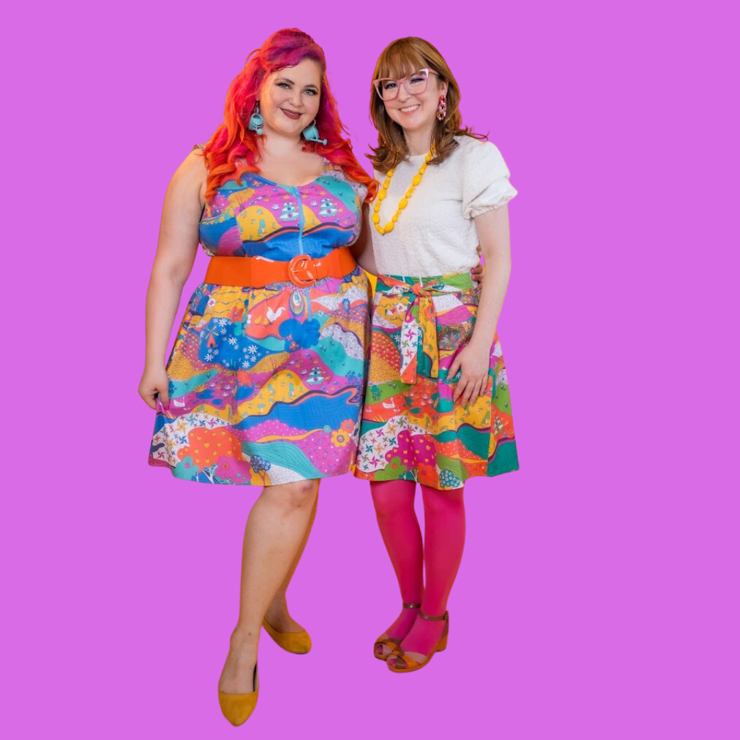 2 models wearing colorful printed clothing on bright pink background