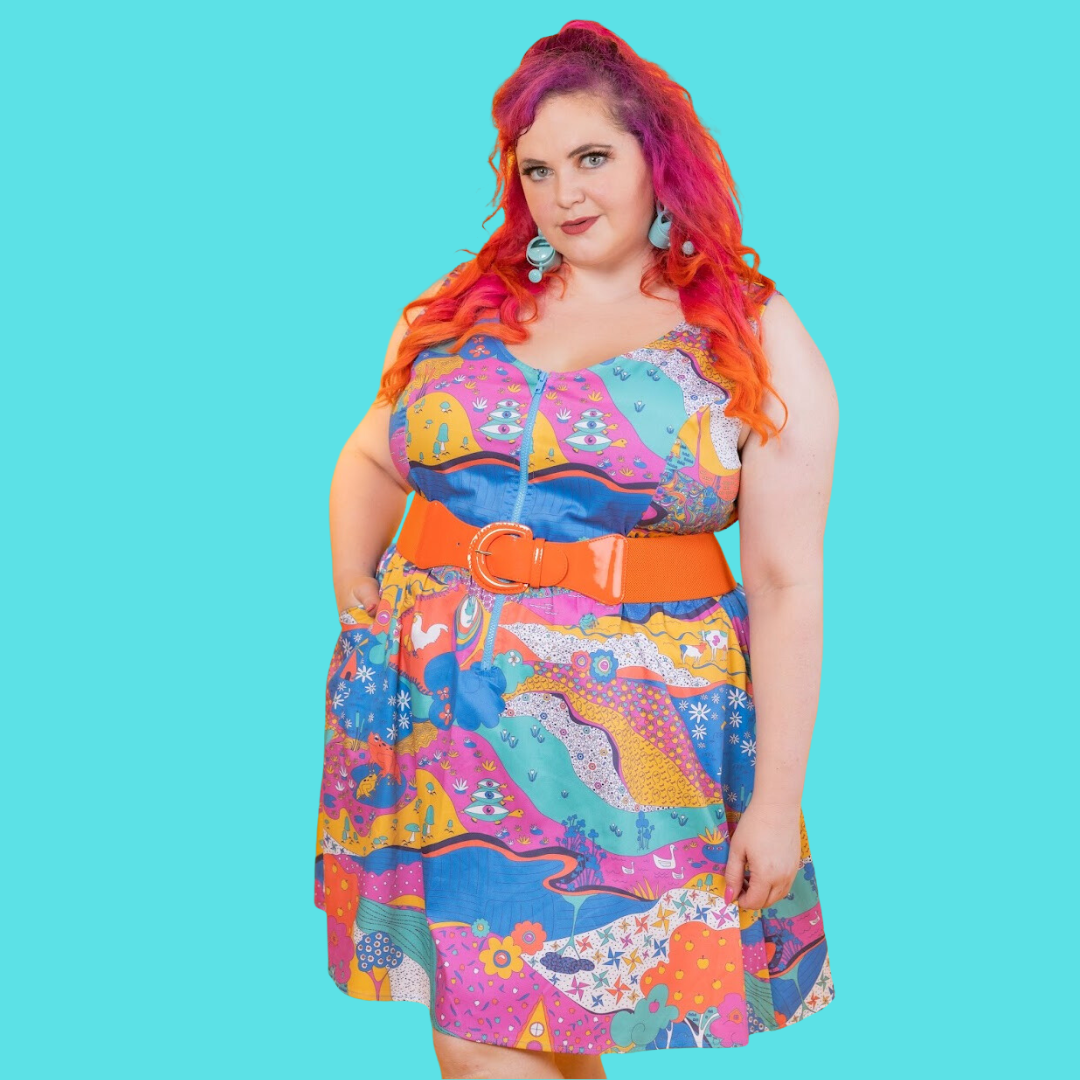 Closeup of red-haired model in funky, colorful sleeveless minidress